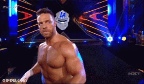 A Man Without A Shirt Is Standing In Front Of A Sign That Says ' La ' On It . GIF