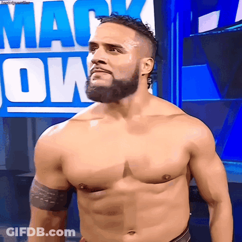 A Man Without A Shirt Is Standing In Front Of A Sign That Says Mack Down GIF