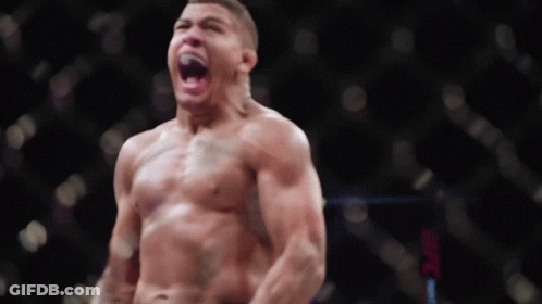A Man Without A Shirt Is Standing In Front Of A Ufc Logo GIF