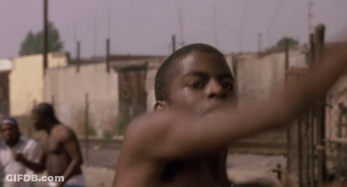 A Man Without A Shirt Is Standing In Front Of A Wall GIF