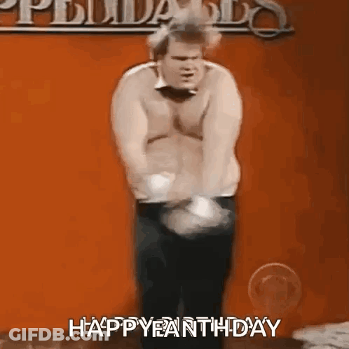 A Man Without A Shirt Is Standing In Front Of An Orange Wall And Says Happy Earth Day . GIF