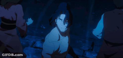 A Man Without A Shirt Is Surrounded By A Group Of People In A Dark Room GIF