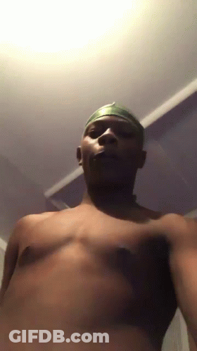 A Man Without A Shirt Is Taking A Selfie In A Dark Room GIF