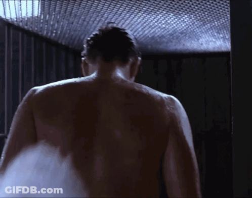 A Man Without A Shirt Is Taking A Shower GIF