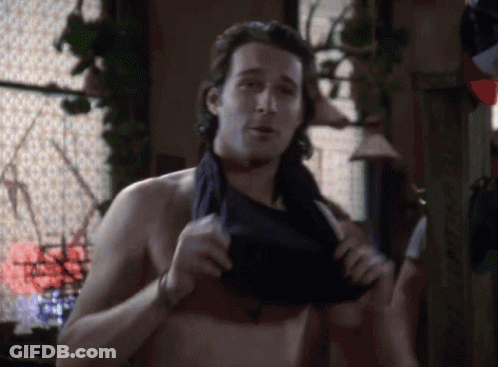 A Man Without A Shirt Is Taking Off His Shirt GIF