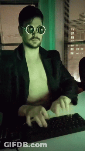 A Man Without A Shirt Is Typing On A Computer Keyboard GIF
