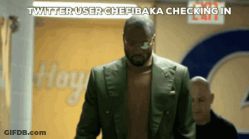 A Man Without A Shirt Is Walking Down A Hallway With The Words Twitter User Chefbaka Checking In Above Him GIF