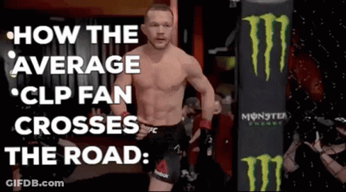 A Man Without A Shirt Is Walking In Front Of A Monster Energy Bag . GIF