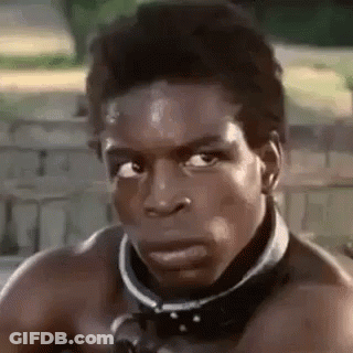 A Man Without A Shirt Is Wearing A Collar Around His Neck And Looking At The Camera . GIF