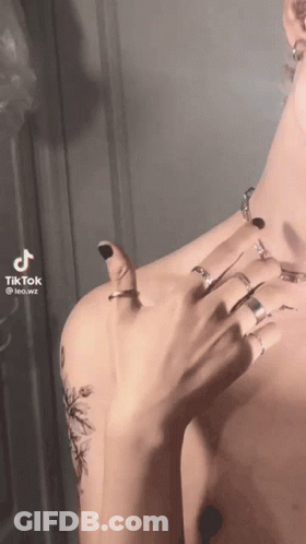 A Man Without A Shirt Is Wearing A Lot Of Rings On His Fingers GIF