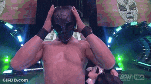 A Man Without A Shirt Is Wearing A Mask And A Tbs Logo Is Behind Him GIF