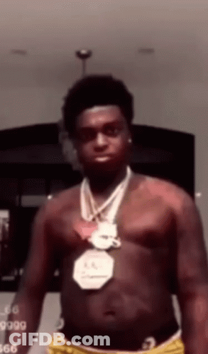 A Man Without A Shirt Is Wearing A Necklace Around His Neck . GIF