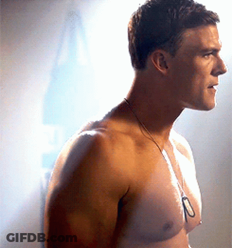 A Man Without A Shirt Is Wearing A Necklace With The Number 10 On It GIF
