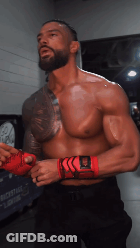 A Man Without A Shirt Is Wearing A Pair Of Red Gloves GIF