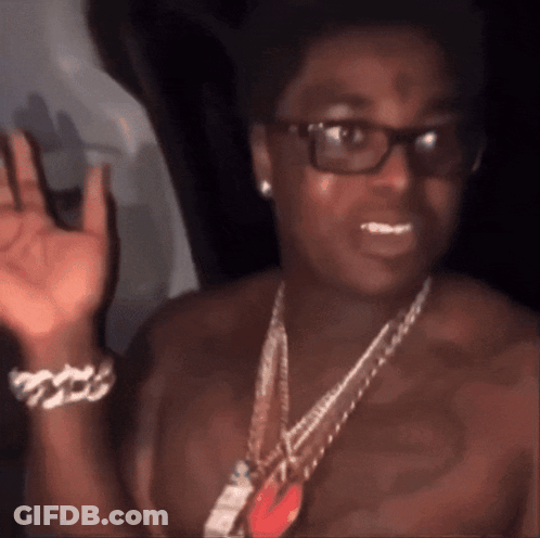 A Man Without A Shirt Is Wearing Glasses And A Chain GIF