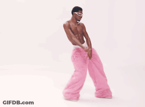 A Man Without A Shirt Is Wearing Pink Pants And Sunglasses GIF