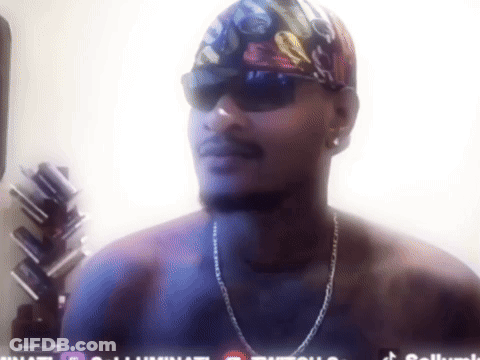 A Man Without A Shirt Is Wearing Sunglasses And A Bandana With A Skull On It GIF
