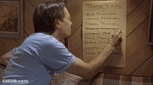 A Man Writes On A Piece Of Paper With People To Kill Written On It GIF