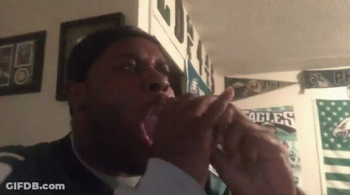 A Man Yawning In Front Of Eagles Posters GIF