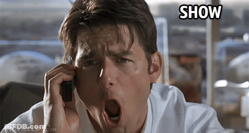 A Man Yawning While Talking On A Cell Phone With The Word Show Above His Head GIF