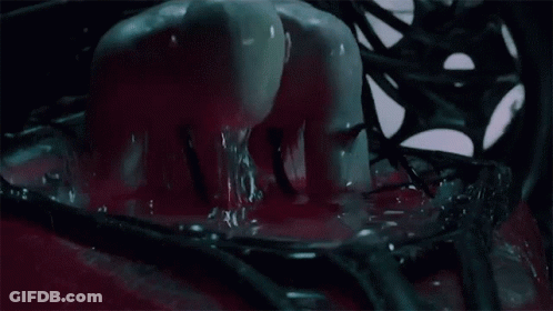 A Mannequin Is Covered In Red Liquid And Crawling Through A Hole In The Floor GIF