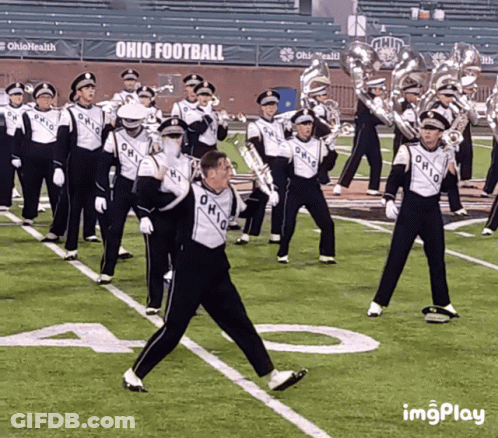 A Marching Band Is Performing On A Field With Ohio Football In The Background GIF