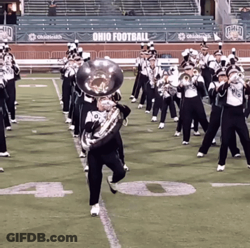 A Marching Band Performs On A Field With Ohio Football Banners GIF