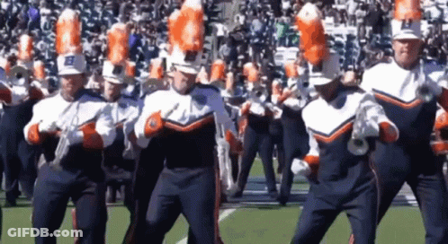 A Marching Band With The Letter B On Their Hats Is Performing On A Field GIF