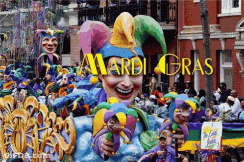A Mardi Gras Parade With A Large Jester Float In The Foreground GIF