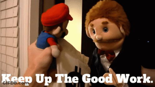 A Mario Puppet Is Being Held By A Person With The Words Keep Up The Good Work Written Below It GIF