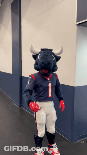 A Mascot Dressed As A Bull Wearing A Jersey With The Number 1 On It GIF