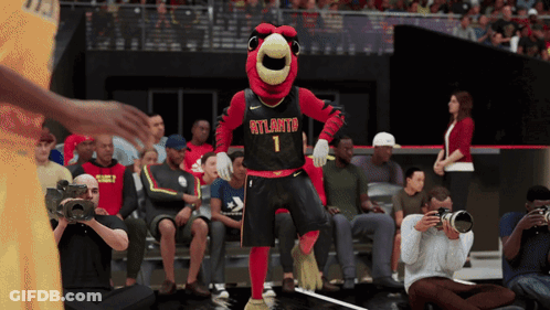 A Mascot For The Atlanta Hawks Is Dancing In Front Of A Crowd GIF