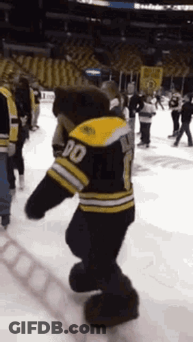 A Mascot For The Boston Bruins Is Dancing On The Ice GIF
