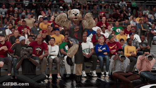 A Mascot For The Cleveland Cavaliers Stands In Front Of A Crowd Of Spectators GIF