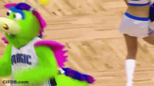 A Mascot For The Dallas Mavericks Is Dancing On A Basketball Court . GIF