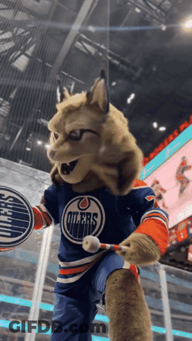 A Mascot For The Edmonton Oilers Is Holding A Hockey Stick GIF