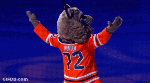 A Mascot For The Edmonton Oilers Is Standing On A Blue Background GIF