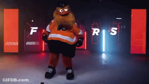 A Mascot For The Flyers Is Standing On A Ice Rink GIF