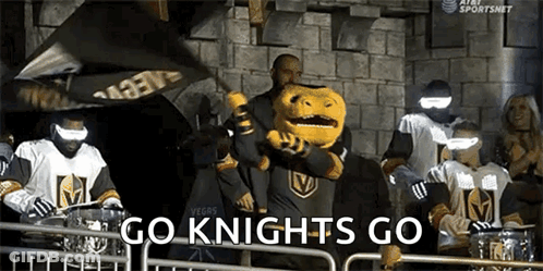 A Mascot For The Golden Knights Is Holding A Flag And Waving It In Front Of A Crowd Of People . GIF