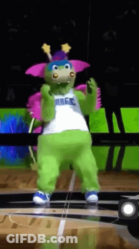 A Mascot For The Magic Basketball Team Is Dancing On A Court GIF