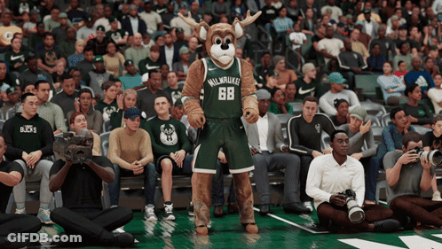 A Mascot For The Milwaukee Bucks Stands On The Court GIF