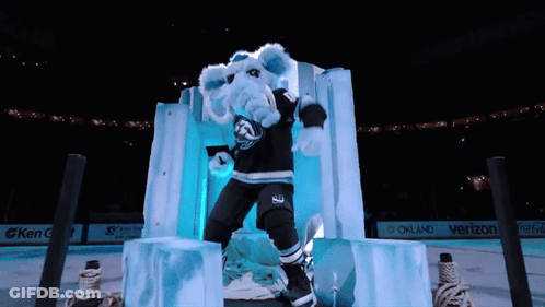 A Mascot For The Oakland Sharks Is Standing On Ice GIF