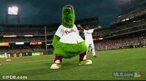 A Mascot For The Phillies Is Dancing On A Baseball Field GIF