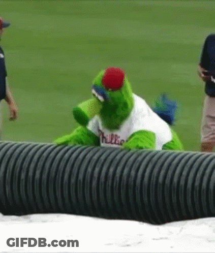 A Mascot For The Phillies Is Sitting On A Black Pipe GIF