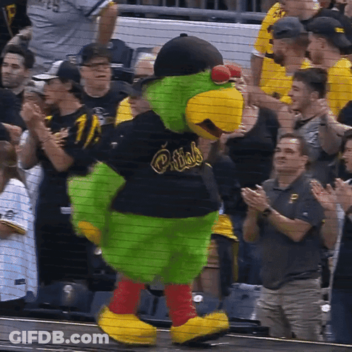 A Mascot For The Pittsburgh Pirates Is Standing In Front Of A Crowd GIF