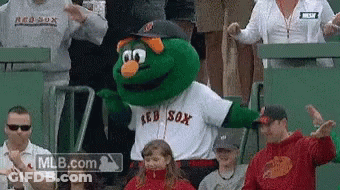 A Mascot For The Red Sox Is Dancing In A Crowd GIF