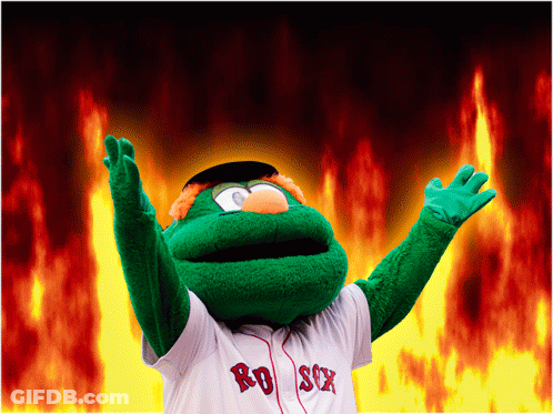 A Mascot For The Red Sox Stands In Front Of A Fire Background GIF