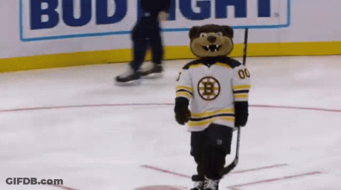 A Mascot Holding A Hockey Stick And Wearing A Jersey With The Letter B On It GIF