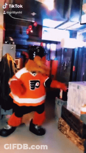 A Mascot In A Flyers Jersey Is Dancing In A Room GIF