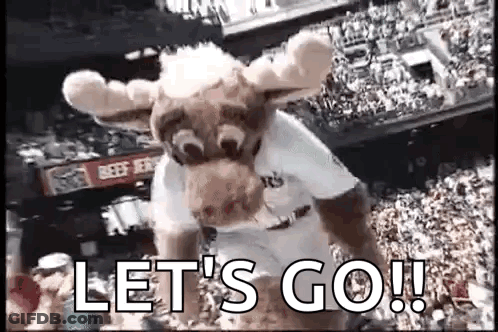 A Mascot In A Moose Costume Is Standing In Front Of A Crowd Of People . GIF